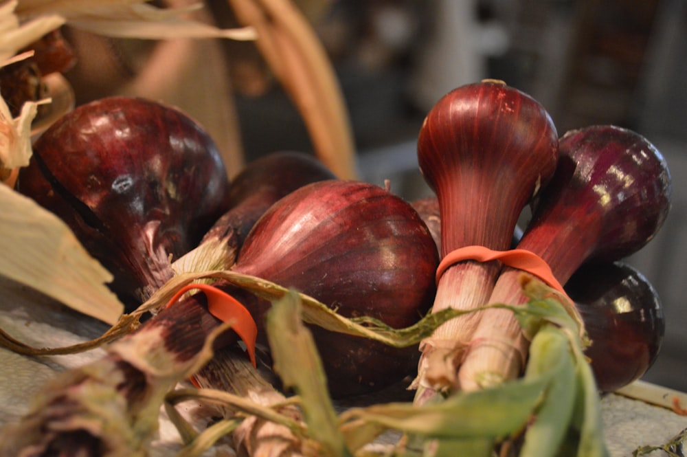 a bunch of red onions sitting on top of a table