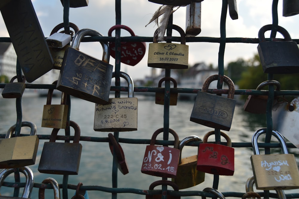 a bunch of padlocks are attached to a fence