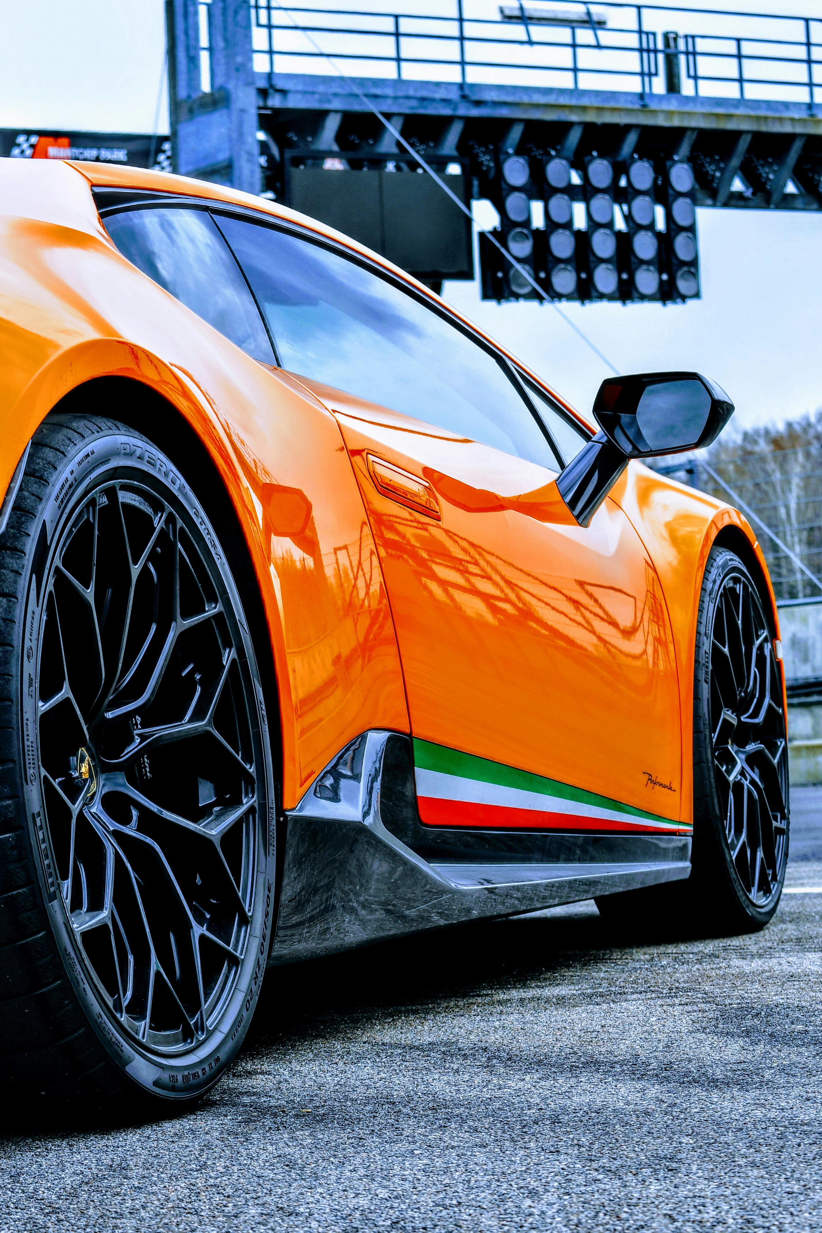 an orange sports car parked in a parking lot