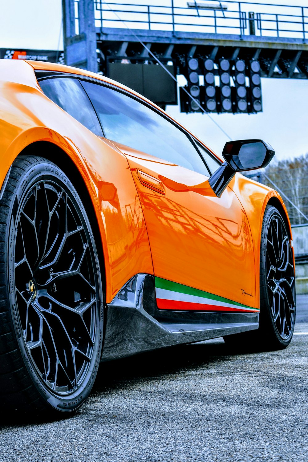 an orange sports car parked in a parking lot