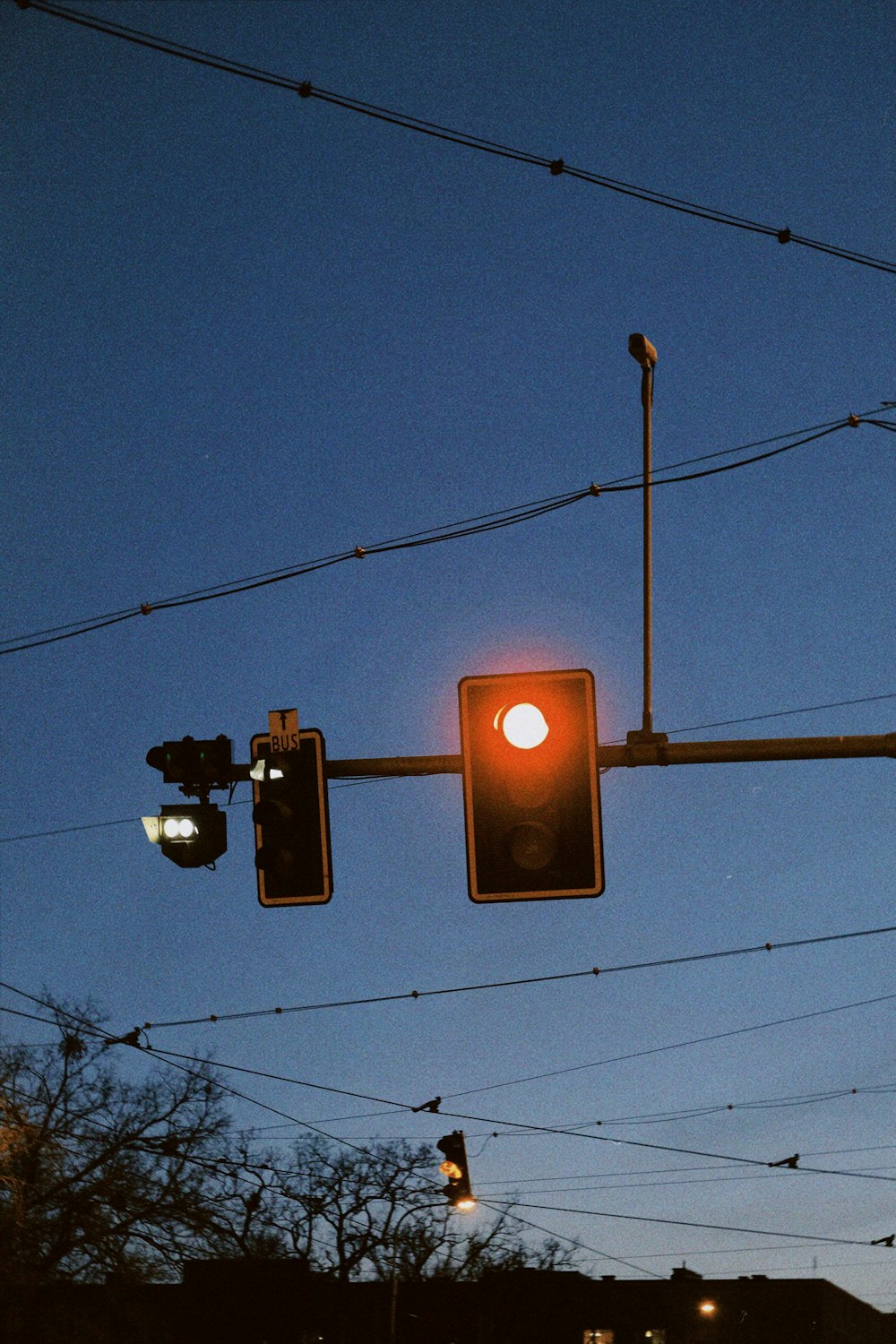 a traffic light hanging over a street at night
