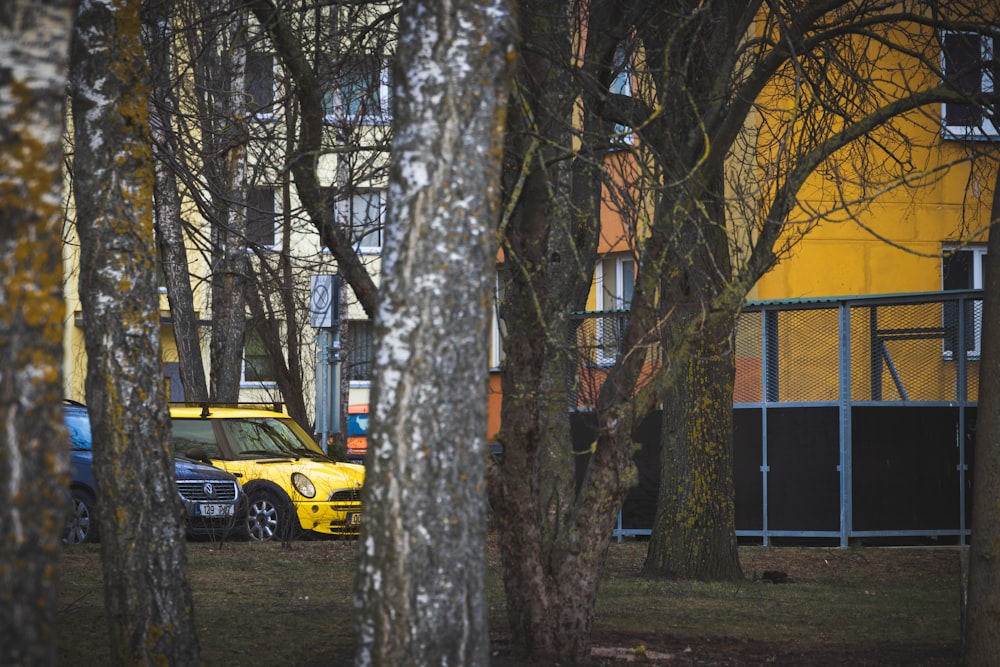 a yellow car parked in front of a yellow building