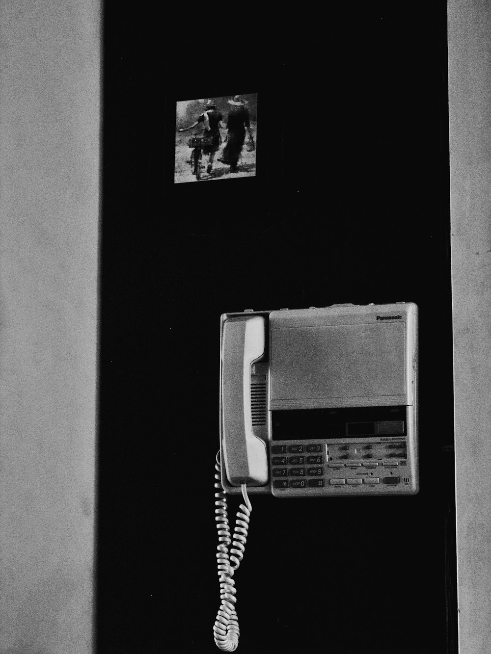 an old phone is attached to a wall