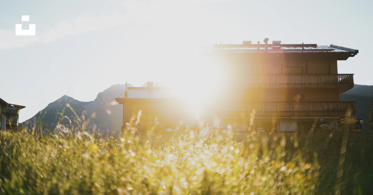 Building Ina Field The sun is shining behind a building in a field photo – Free Flare ...