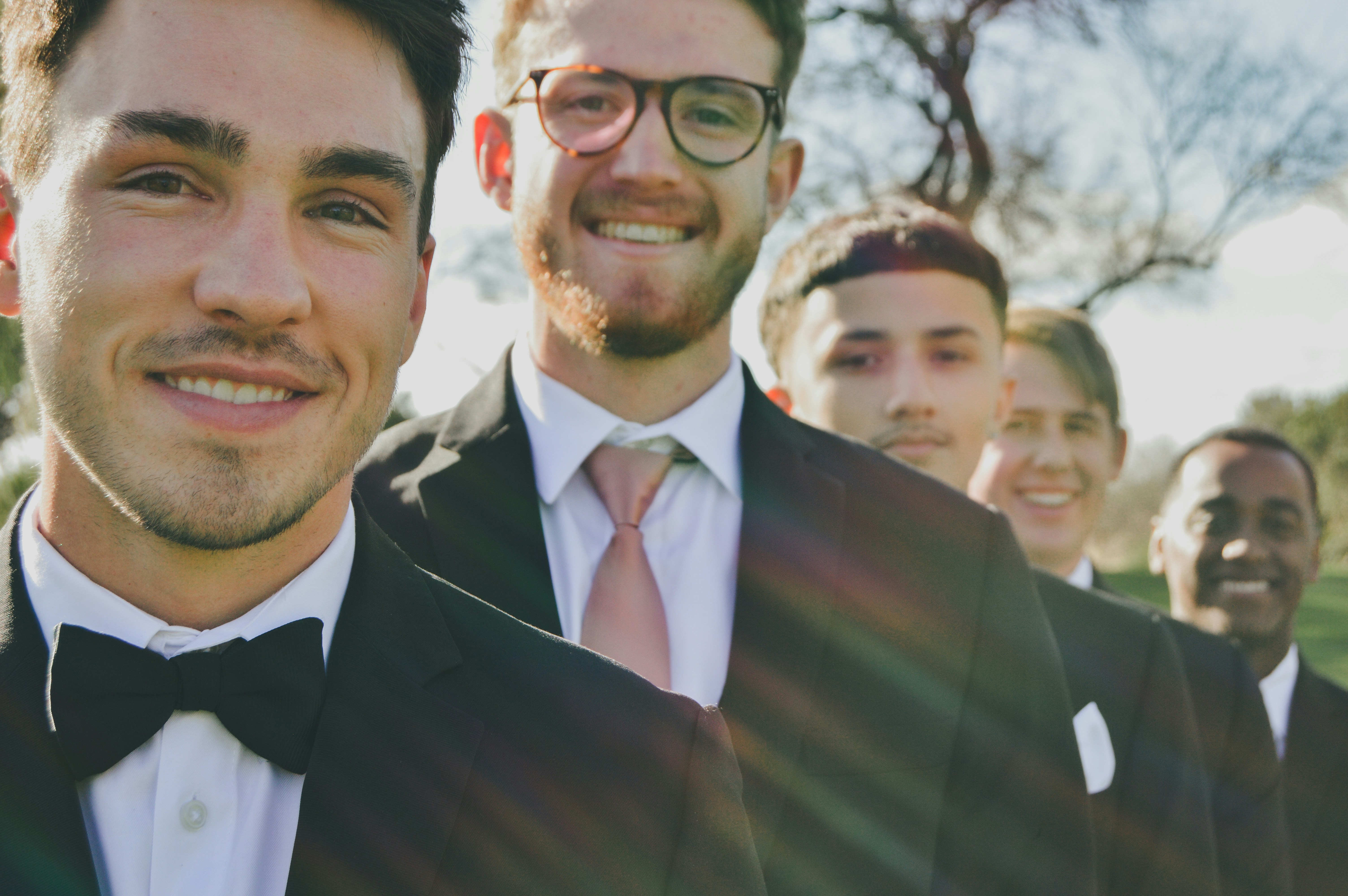 a group of men in tuxedos standing next to each other