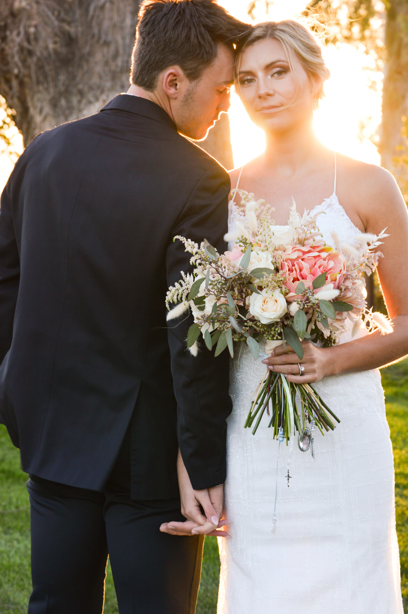Couple in wedding attire together in warm golden light