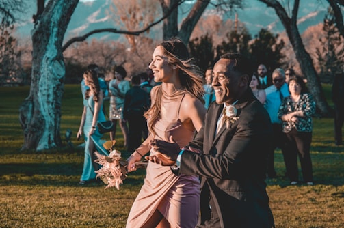 A bright outdoor wedding scene with happy couples.