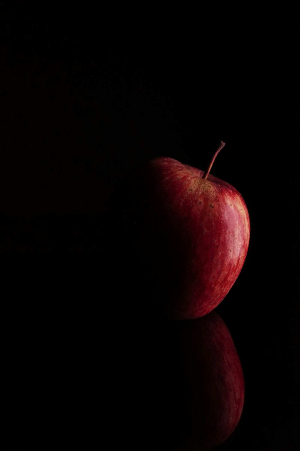 a red apple sitting on top of a table
