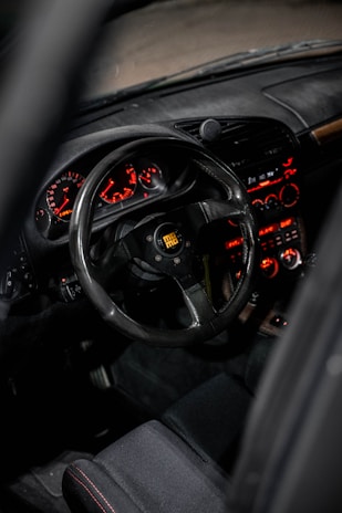 the dashboard of a car with a steering wheel and dashboard lights