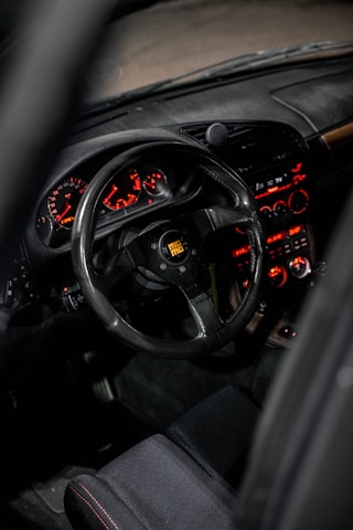 the dashboard of a car with a steering wheel and dashboard lights
