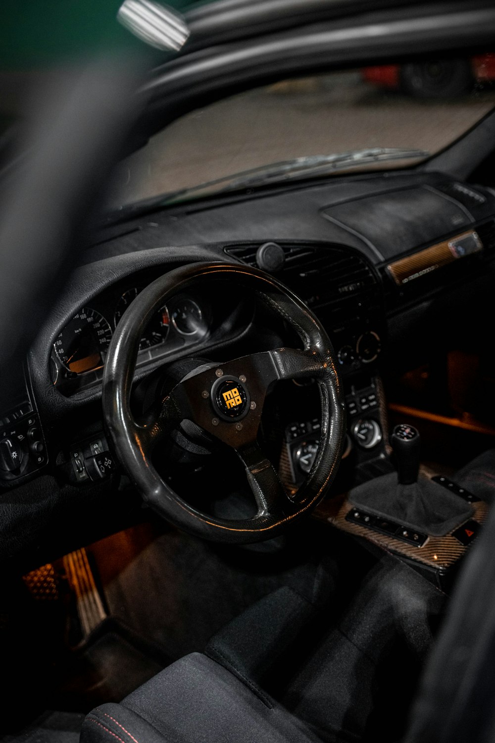 the interior of a car with a steering wheel and dashboard