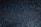 A textured surface with a shimmering effect created by numerous tiny reflective particles spread across a dark background.