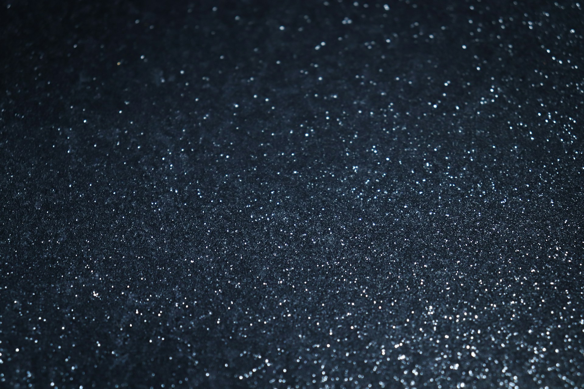 a close up of a black background with white dots
