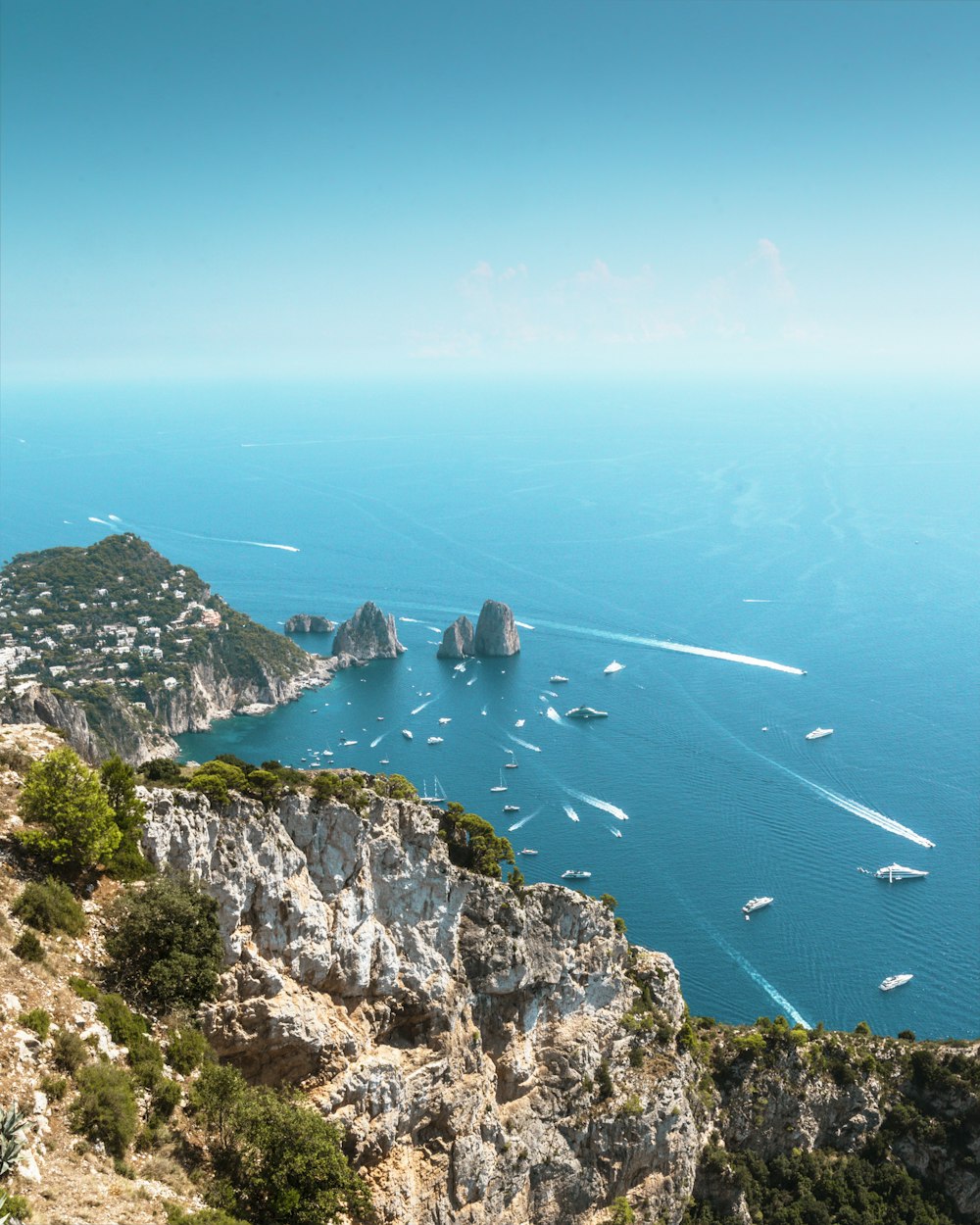 a group of boats floating on top of a large body of water