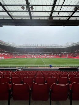 A dynamic shot of a Manchester United player sprinting down the pitch with the stadium roaring in the background.