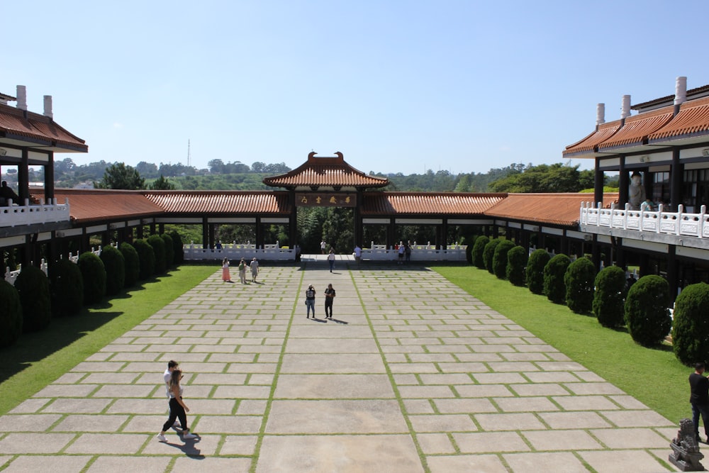 a group of people walking around a courtyard