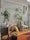 a room filled with lots of plants and furniture