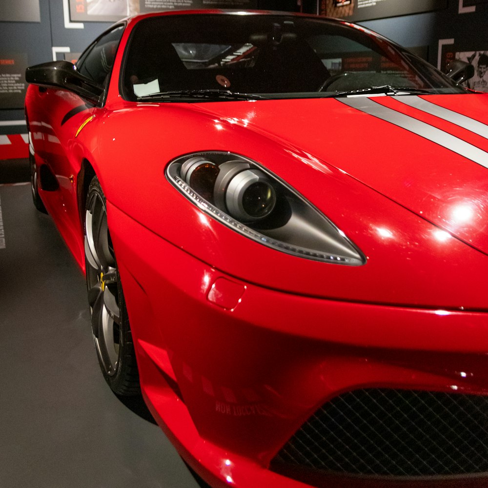 a red sports car is on display in a museum