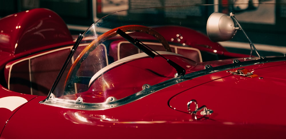 a close up of the front of a red sports car