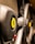 The image focuses on the steering wheel of a luxury sports car, featuring a prominent yellow emblem with a black prancing horse. The leather texture and sleek design elements suggest high-quality craftsmanship.