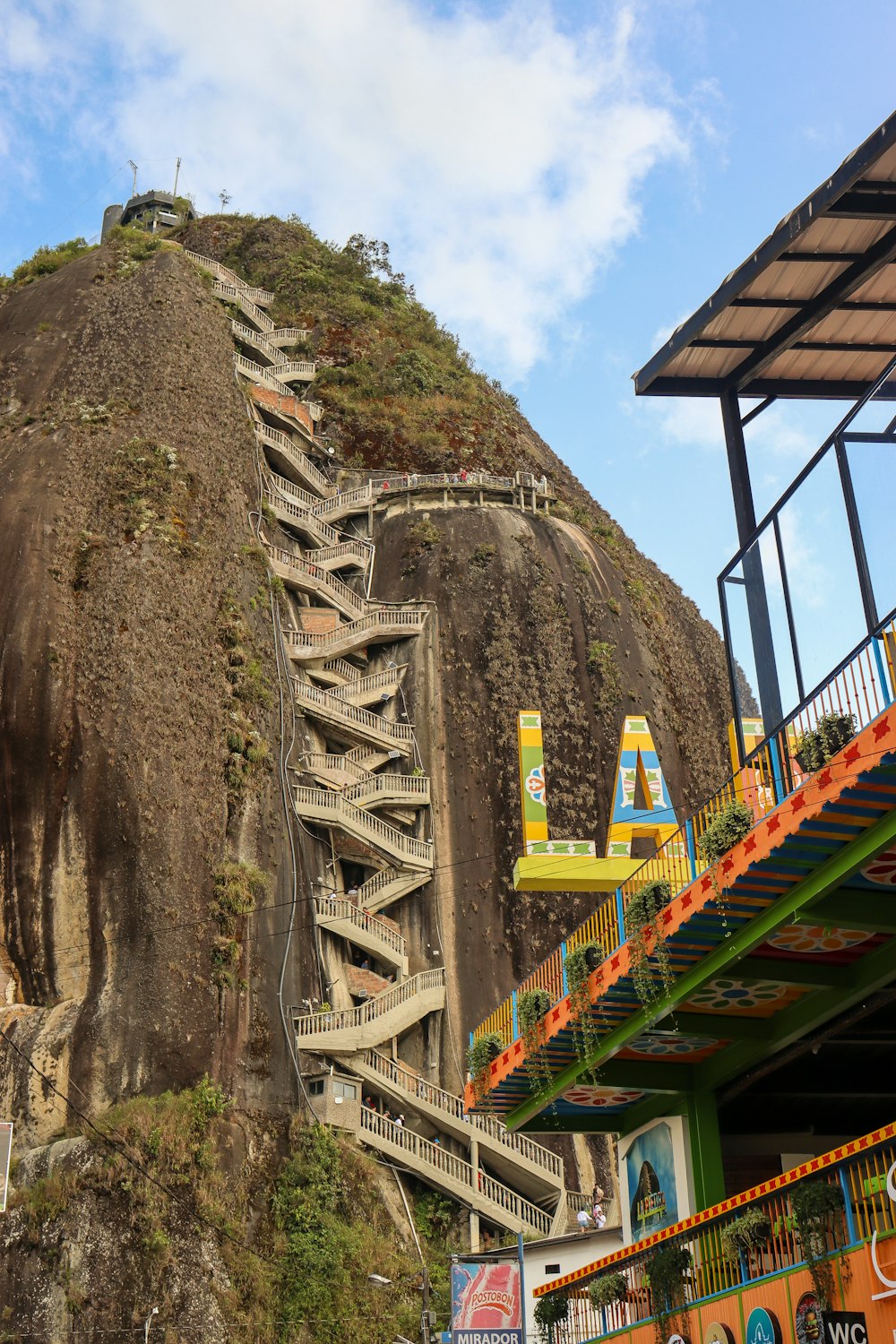 a very tall mountain with a bunch of stairs going up it