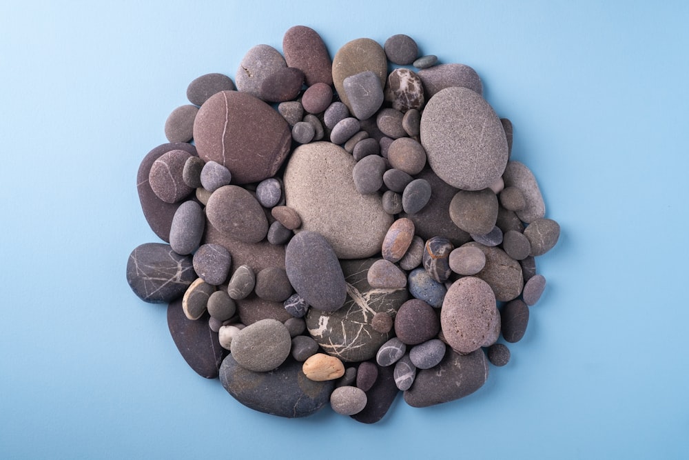 a pile of rocks sitting on top of a blue surface