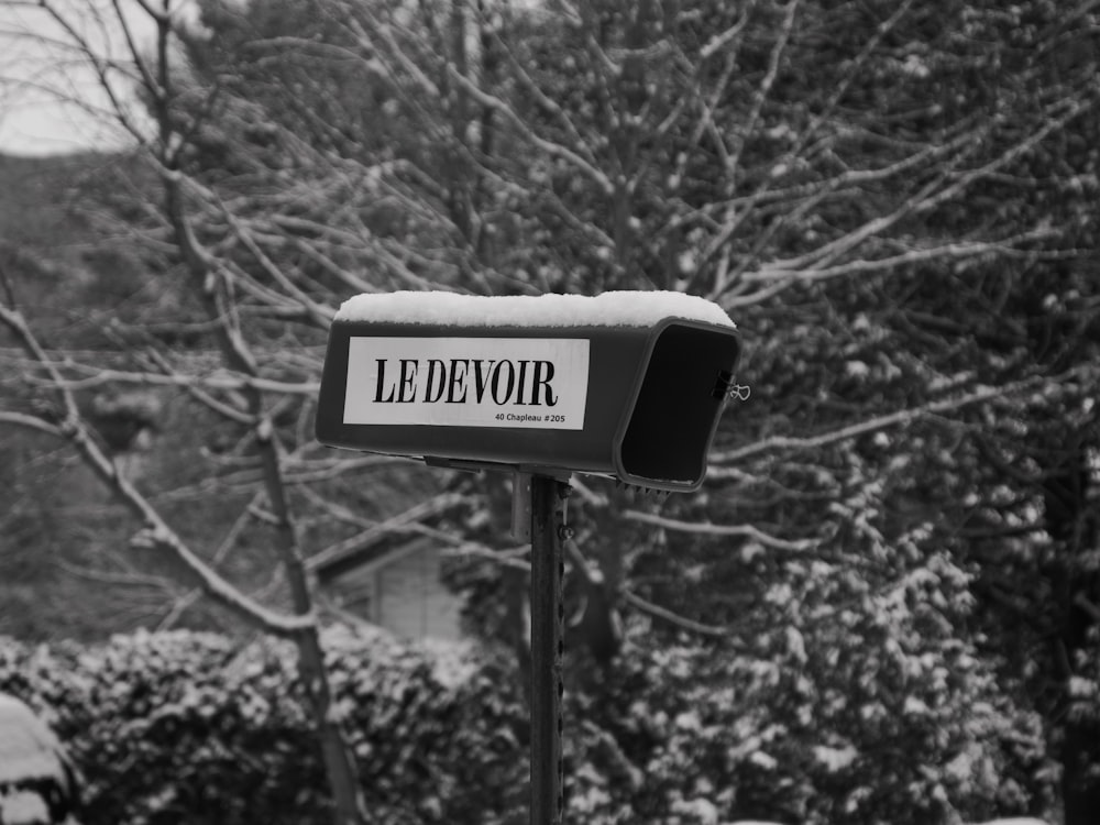 a black and white photo of a mailbox