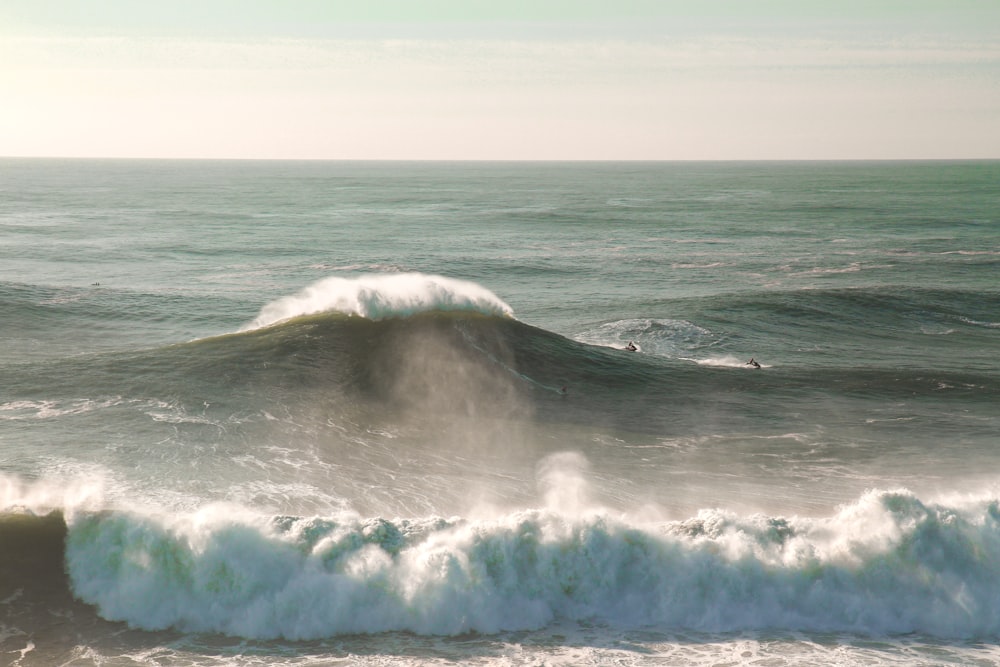 a person riding a surfboard on a wave in the ocean