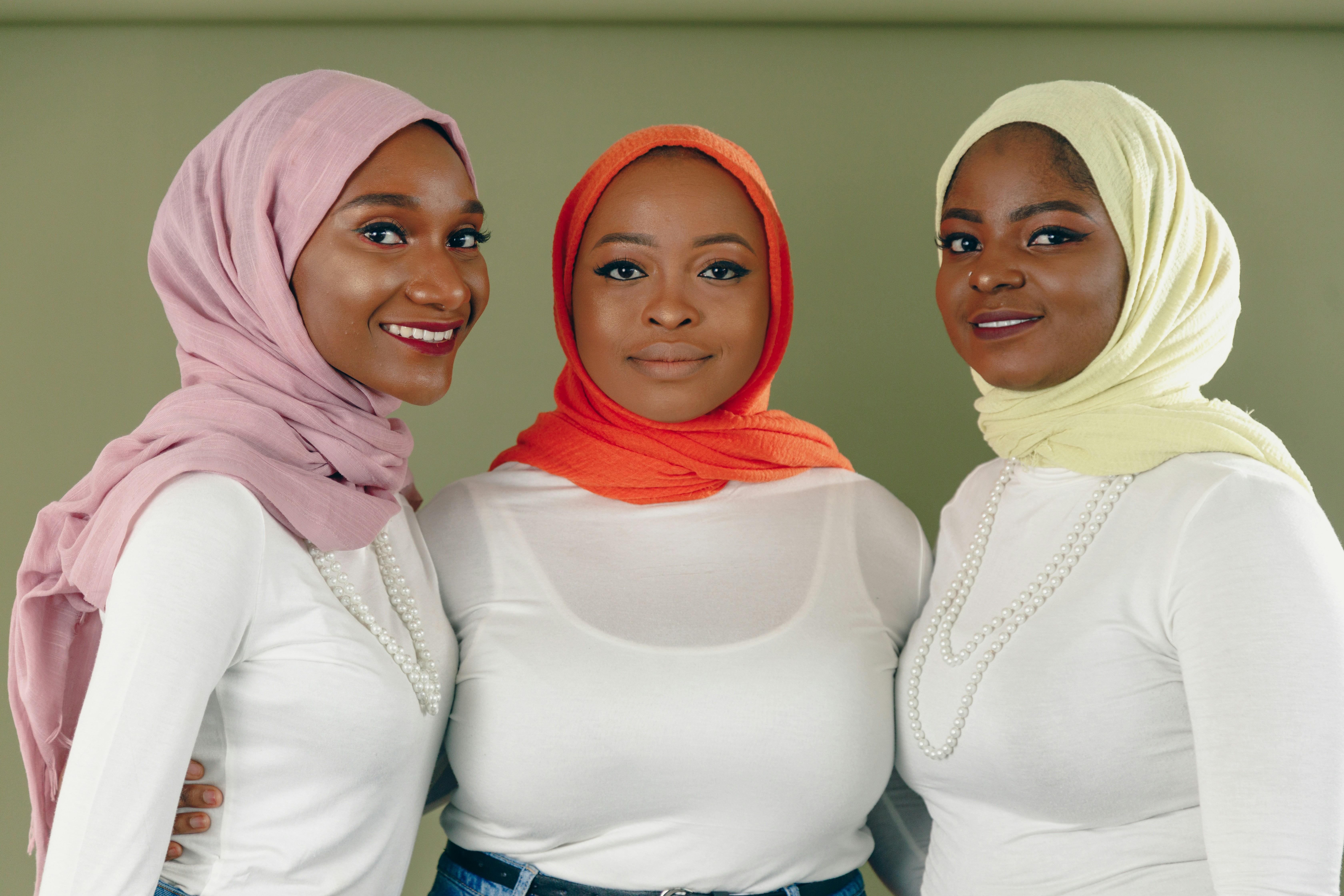 a group of three women standing next to each other