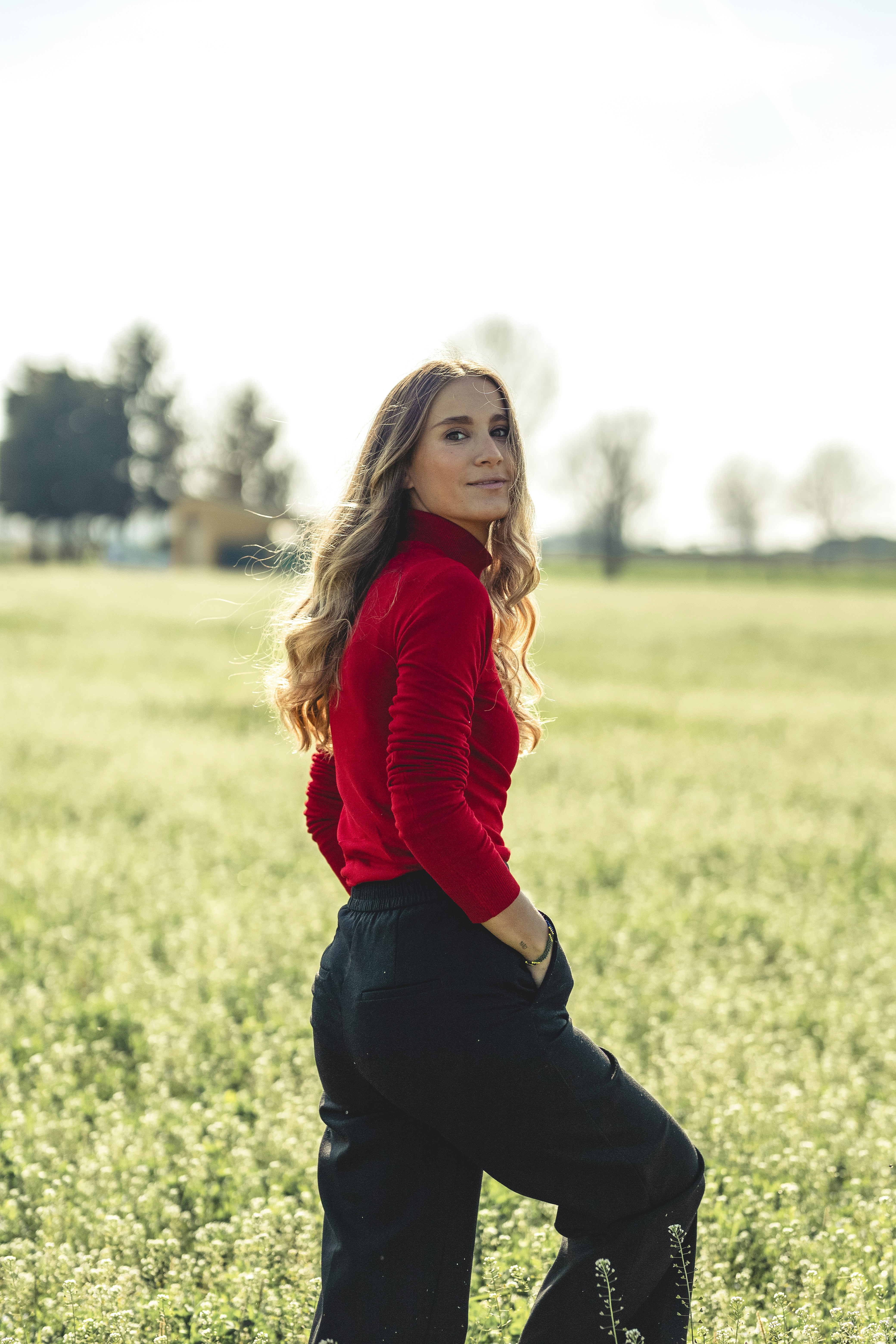 a woman standing in a field of tall grass