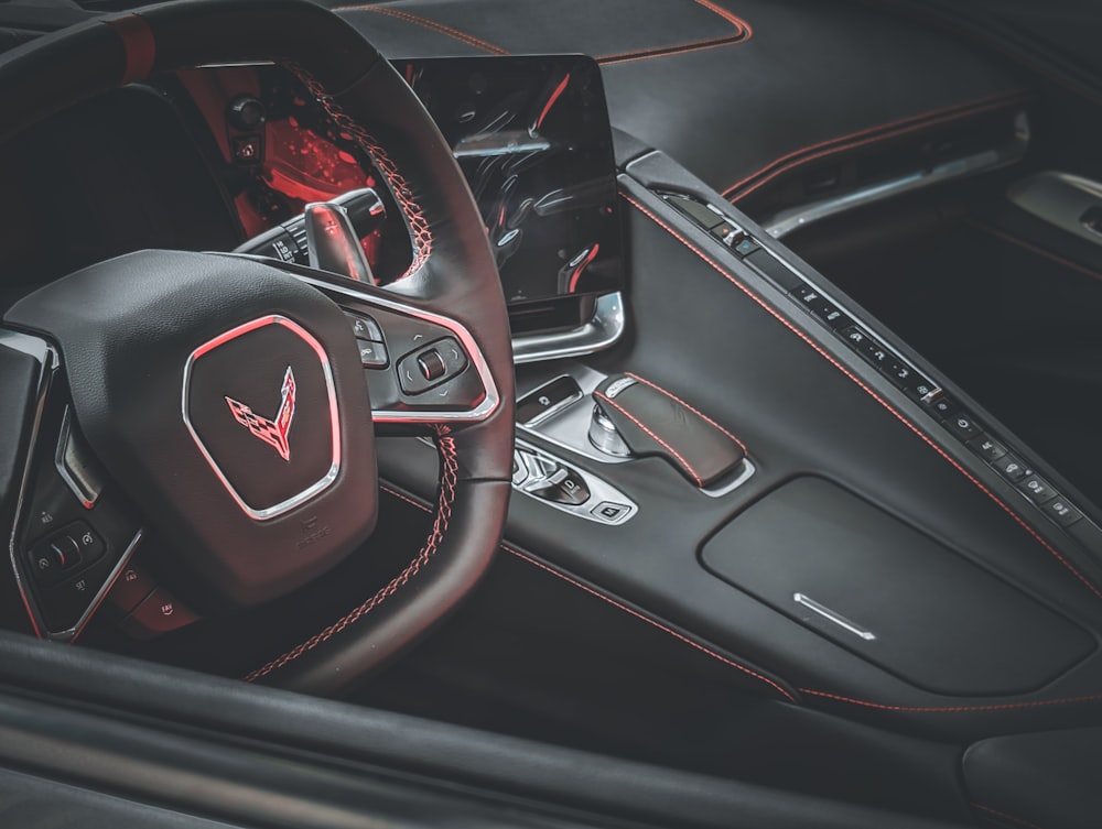 a close up of a car's steering wheel and dashboard