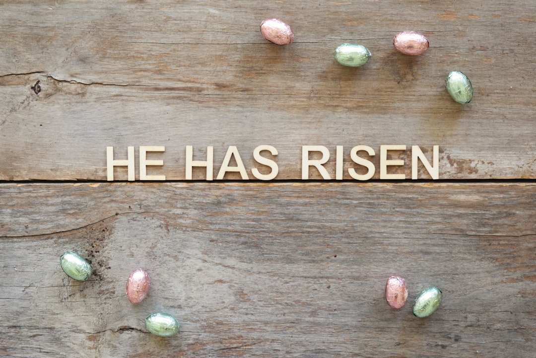 a wooden sign that says he has risen on it