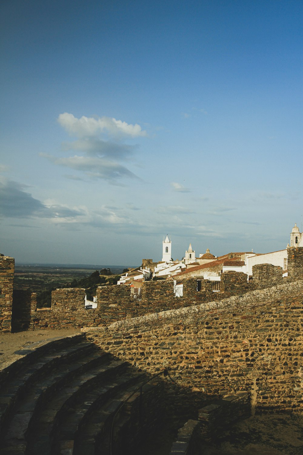 a view of a city from a stone wall