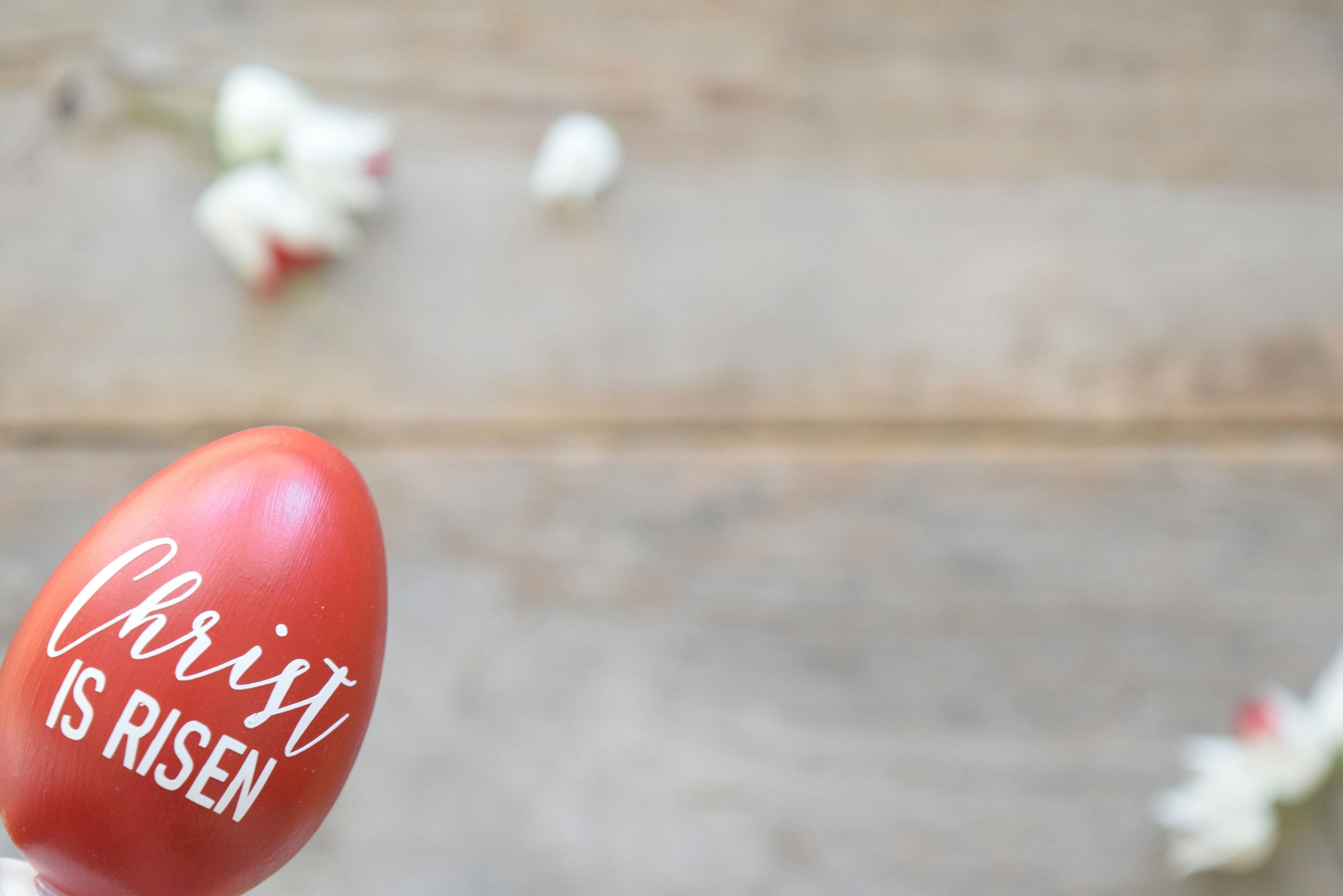 A faux red egg and a decal with the words Christ is Risen on it.