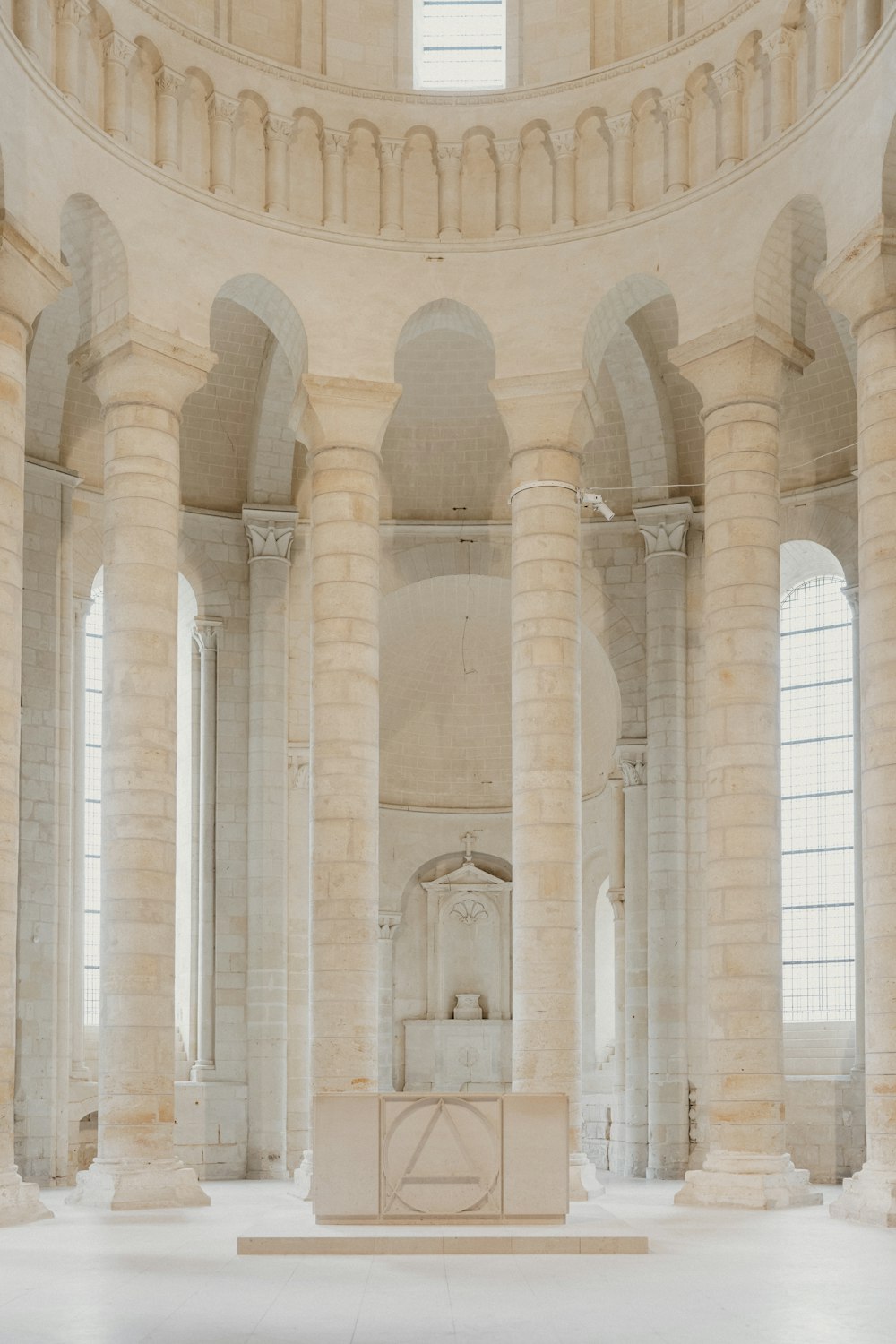 a room with columns and a statue in it