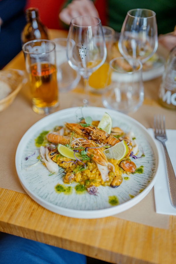 A plate of food on a table with wine glasses