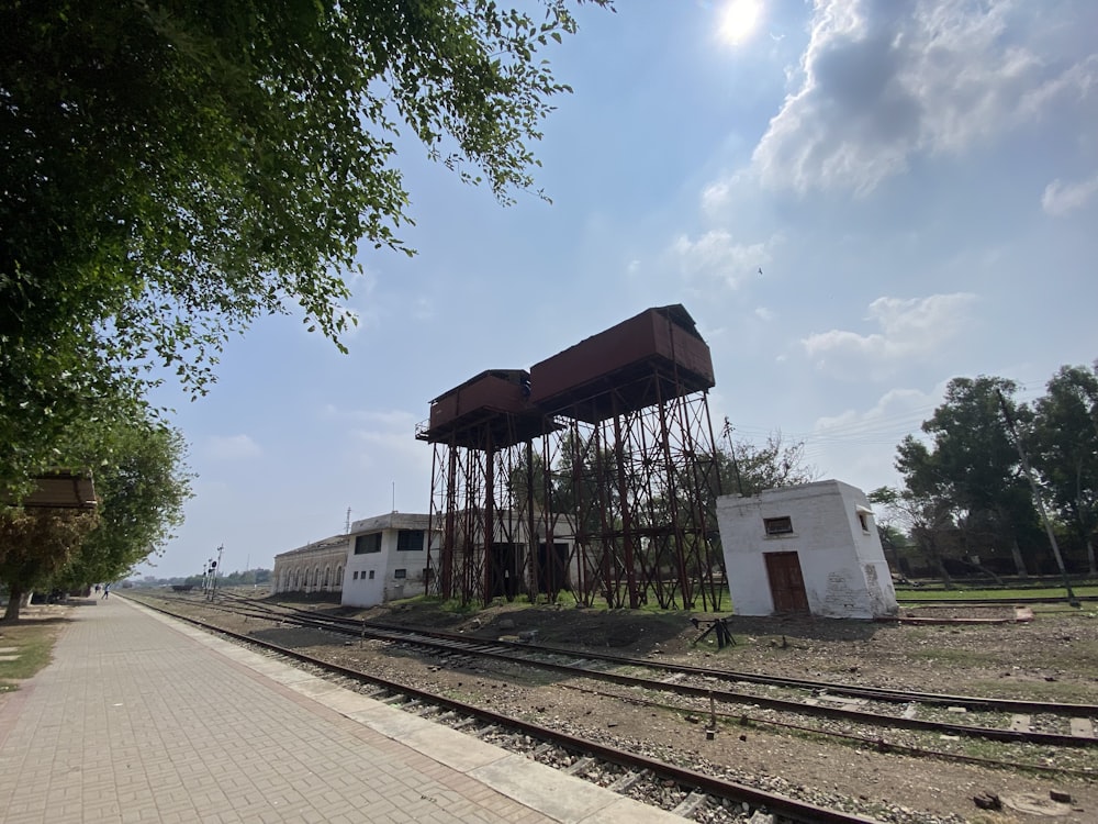 a train track next to a building and trees