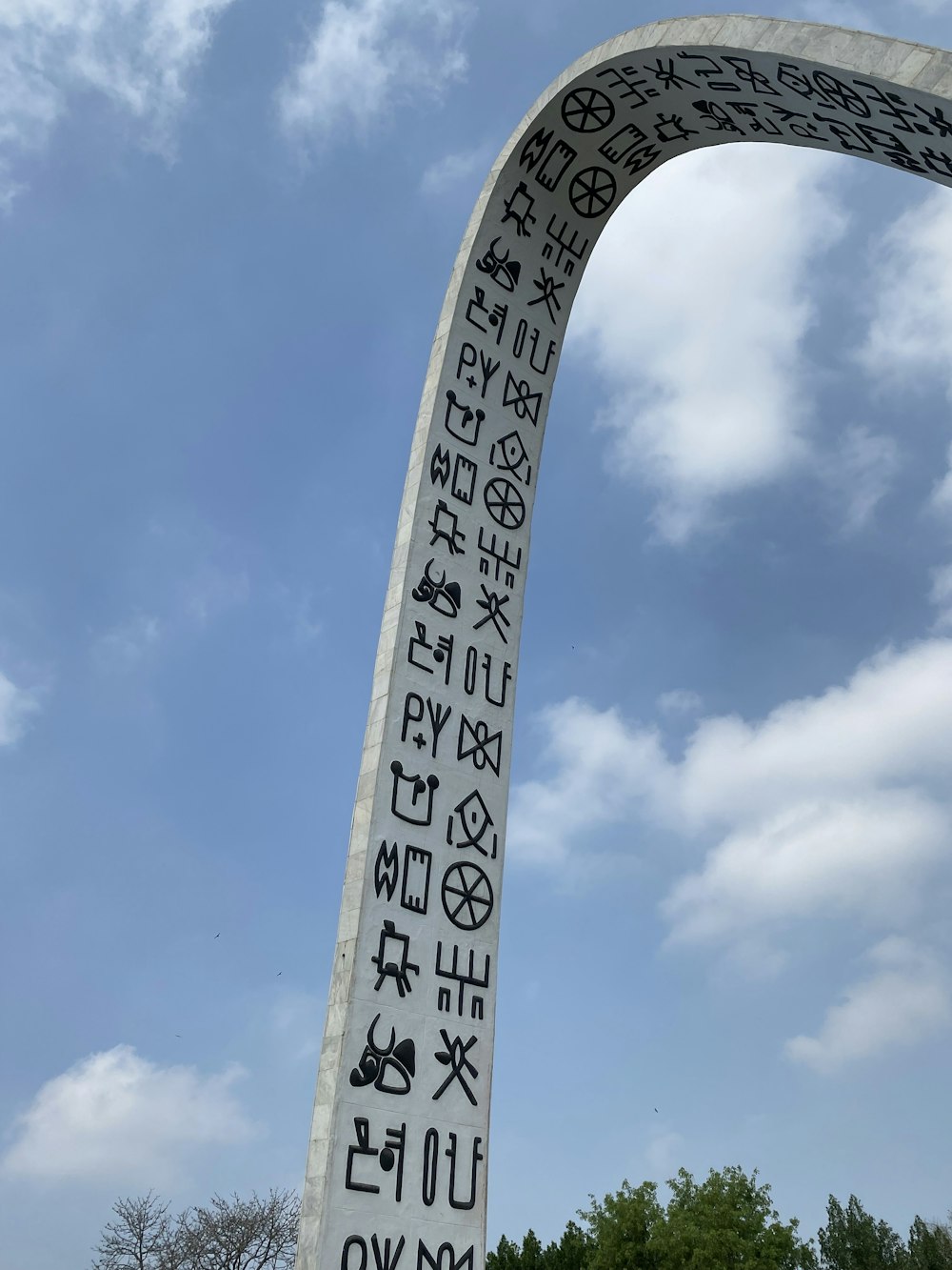 a tall white monument with writing on it