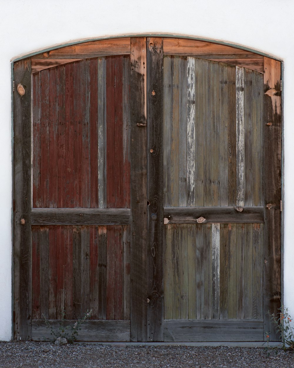 a wooden door with a white wall behind it