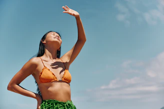 a woman in a bikini standing on the beach
