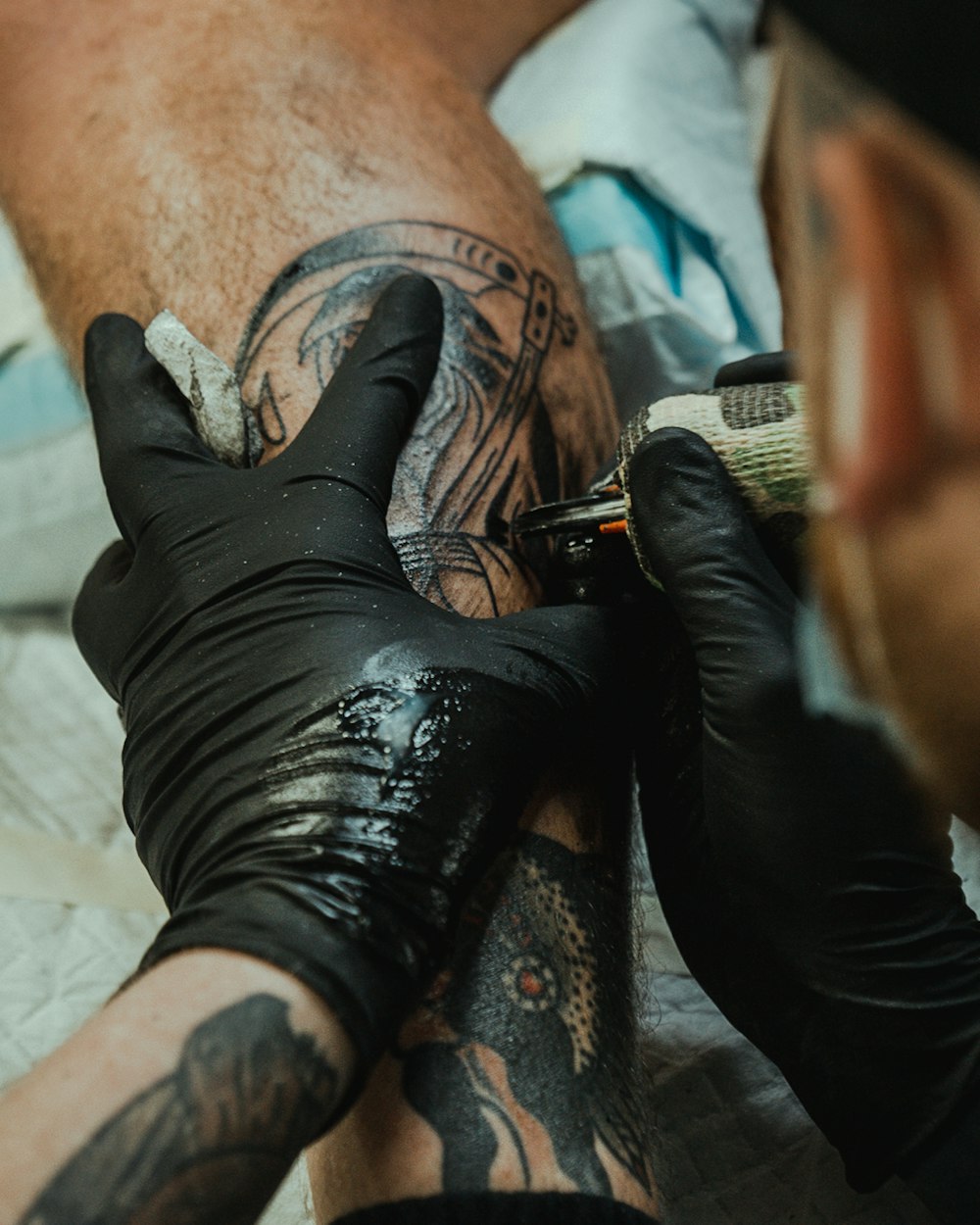 a man getting a tattoo done on his leg