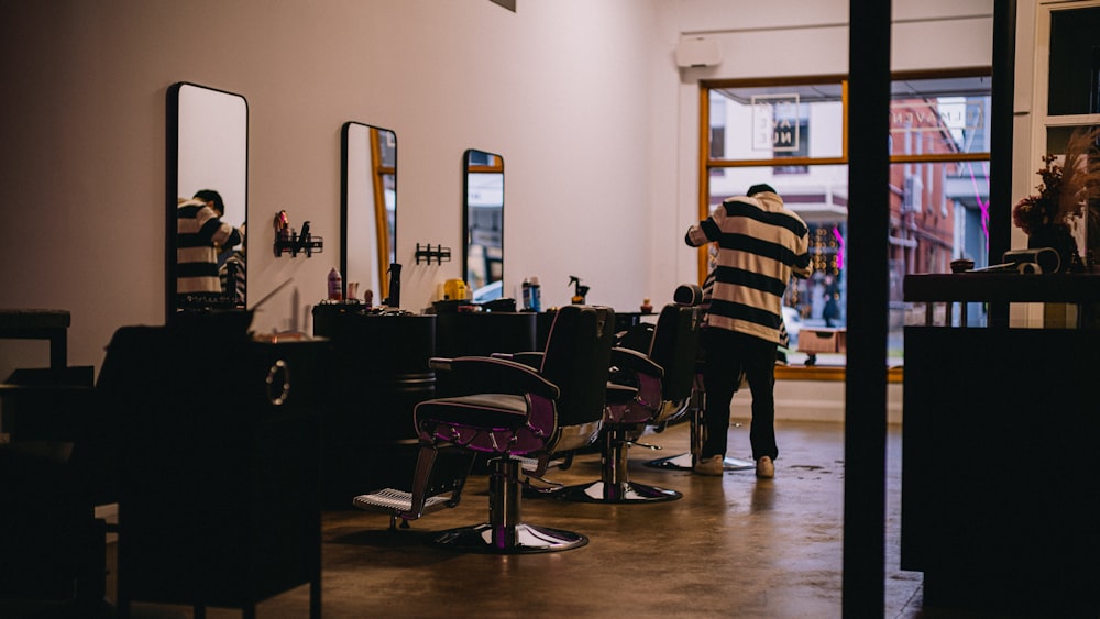 a man getting his hair cut in a barber shop