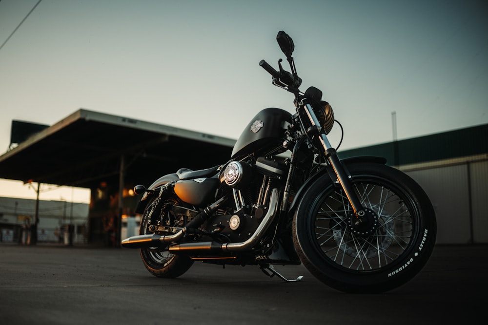 a black motorcycle parked in front of a building