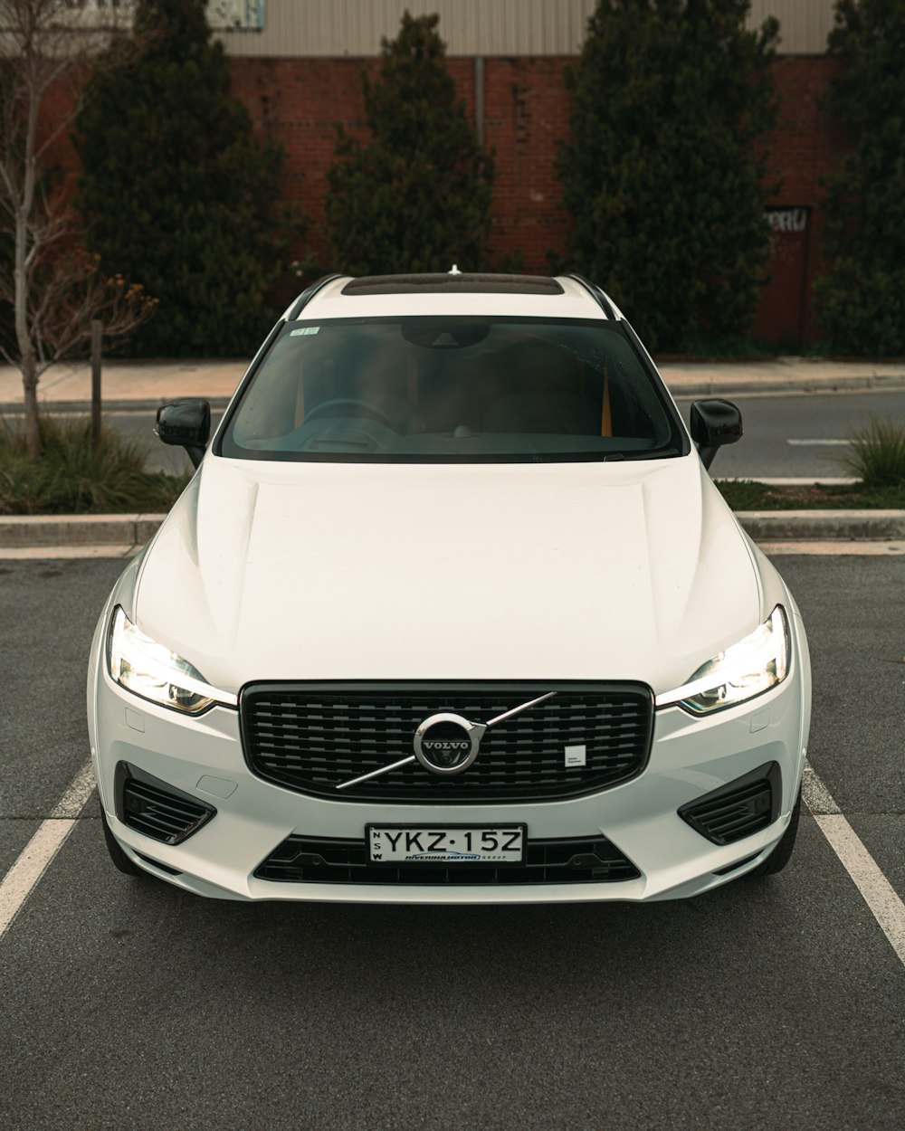 a white volvo car parked in a parking lot