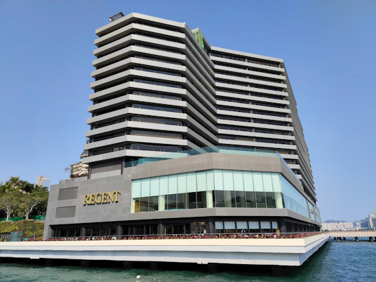 A sleek, modern commercial building showcasing a completed Regent Contracting project under clear skies.