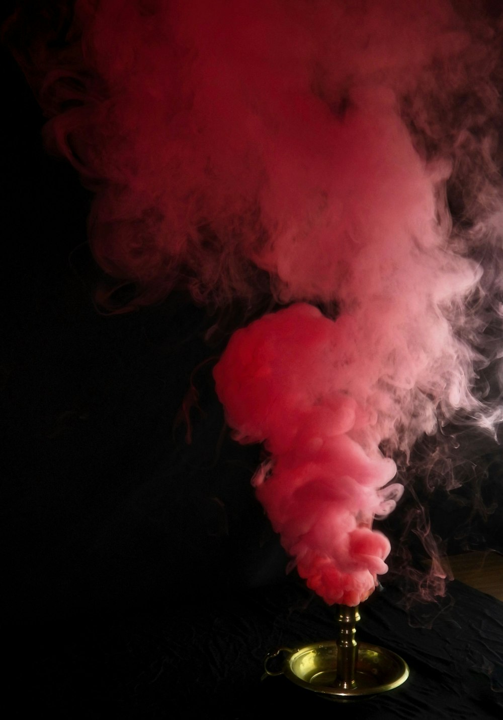 a red smoke billowing out of a pipe