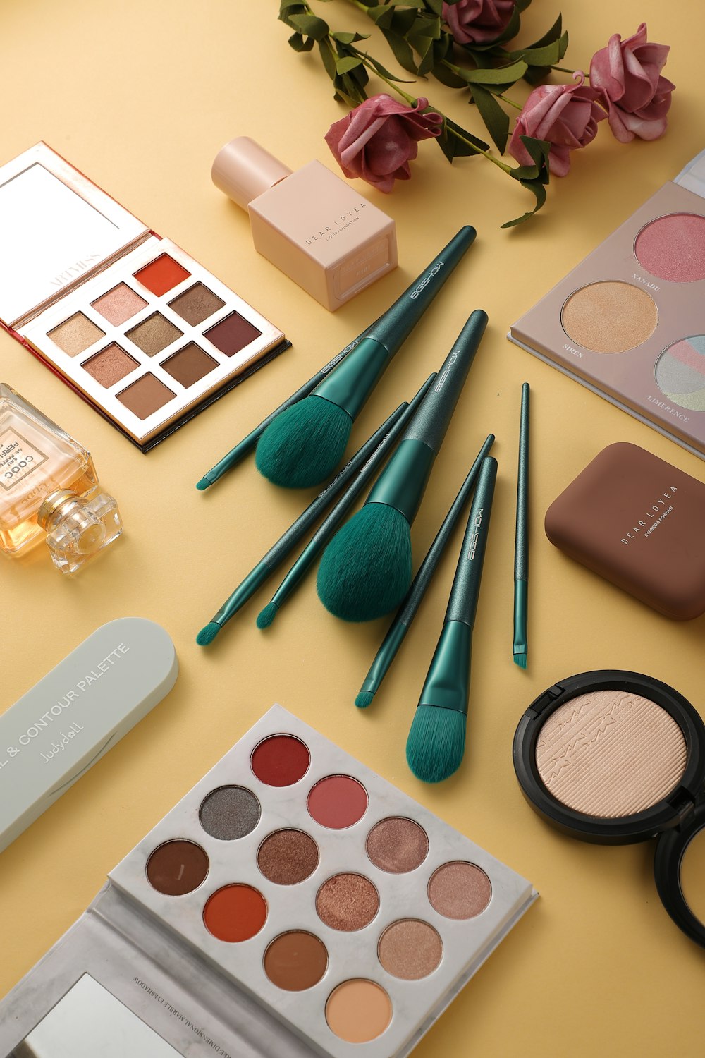 a collection of makeup and cosmetics on a table