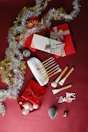 a red table topped with lots of christmas decorations