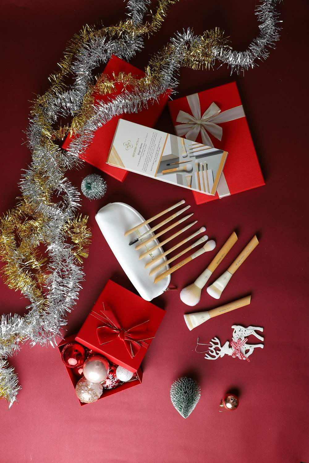 a red table topped with lots of christmas decorations