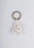 A custom 3D printed keyring featuring intricate details and a shiny finish.